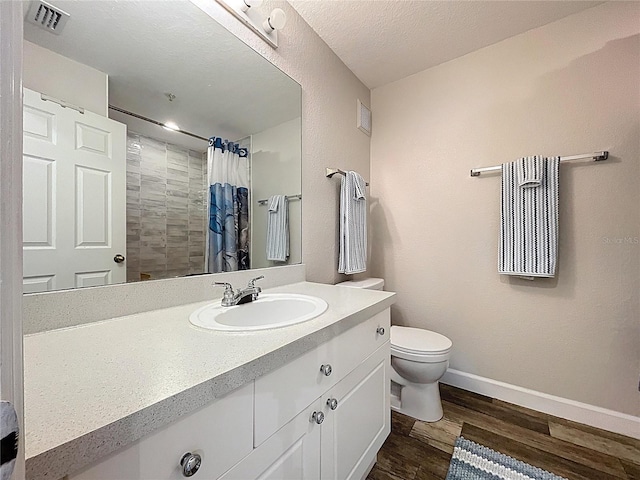 18001 Richmond Place Dr Unit 330, Tampa, FL 33647 - full bath with wood finished floors, baseboards, toilet, vanity, and a shower with curtain