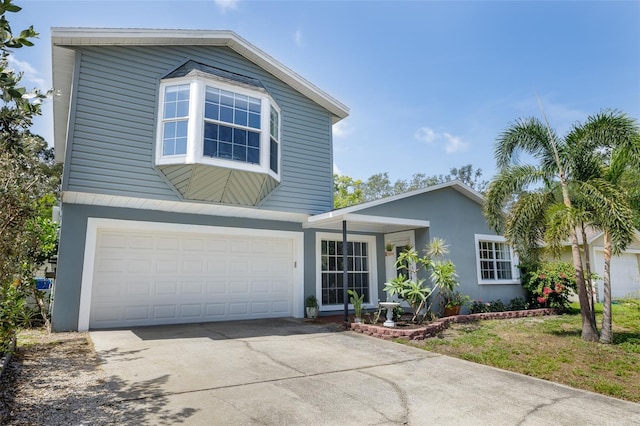 12913 126th Ter, Largo, FL 33774 - view of front of house featuring driveway, stucco siding, and an attached garage