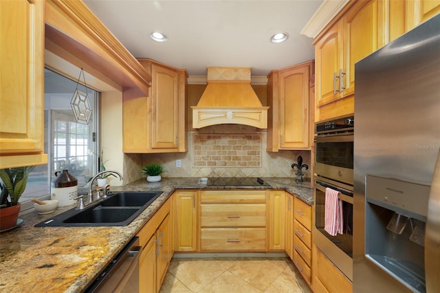 12913 126th Ter, Largo, FL 33774 - kitchen with appliances with stainless steel finishes, a sink, premium range hood, tasteful backsplash, and dark stone countertops