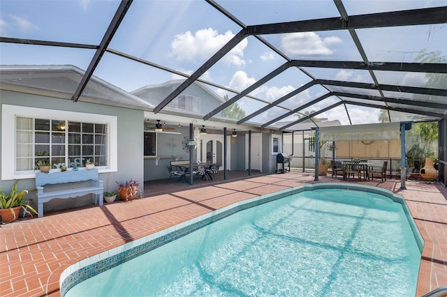 12913 126th Ter, Largo, FL 33774 - swimming pool featuring outdoor dining space, a patio, a ceiling fan, and glass enclosure