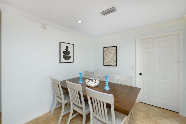 12913 126th Ter, Largo, FL 33774 - dining area with ornamental molding and light tile patterned flooring