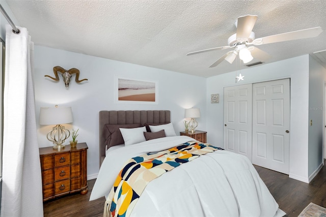 12913 126th Ter, Largo, FL 33774 - bedroom with dark wood-style flooring, a closet, a textured ceiling, a ceiling fan, and baseboards