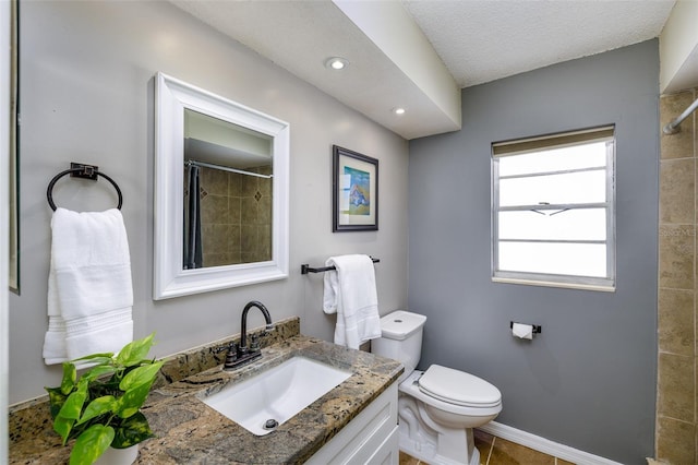 12913 126th Ter, Largo, FL 33774 - bathroom with vanity, a tile shower, toilet, and recessed lighting