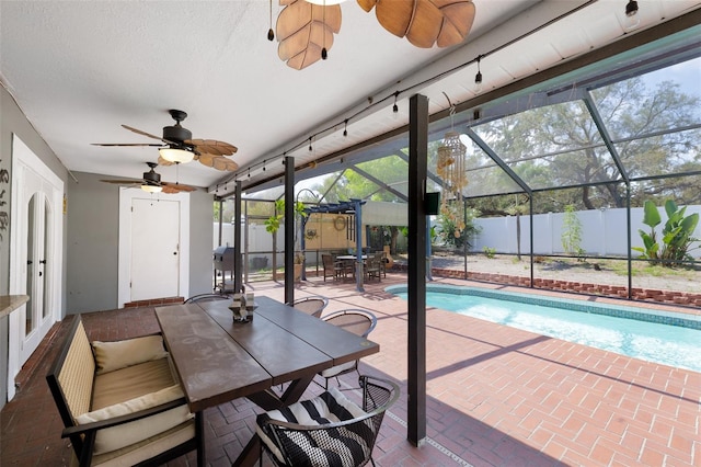 12913 126th Ter, Largo, FL 33774 - sunroom / solarium with a ceiling fan, outdoor dining area, a pool, and plenty of natural light