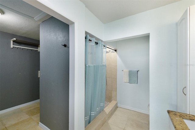 12913 126th Ter, Largo, FL 33774 - bathroom with a tile shower, tile patterned flooring, and baseboards
