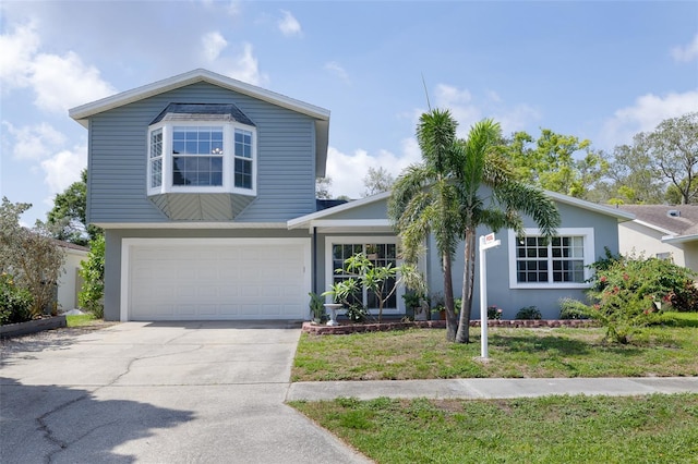 12913 126th Ter, Largo, FL 33774 - view of front facade with a garage, driveway, stucco siding, and a front lawn