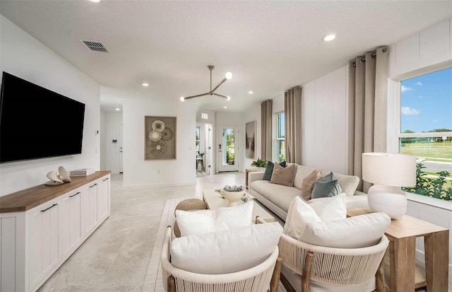 8303 SW 54th Loop, Ocala, FL 34481 - living room featuring plenty of natural light, a chandelier, and recessed lighting