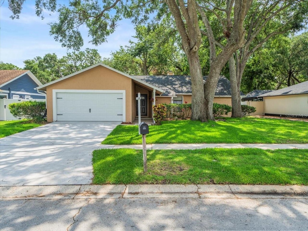 16015 Glen Haven Dr, Tampa, FL 33618 - single story home with a garage, concrete driveway, and stucco siding