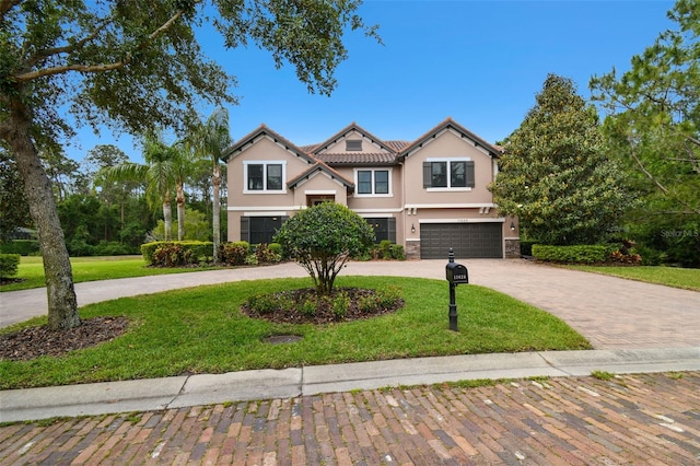 11624 Calf Path Dr, Tampa, FL 33626 - view of front of home featuring curved driveway, stucco siding, a garage, and a front yard