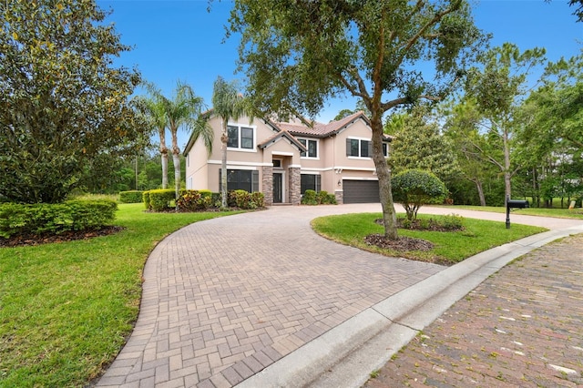 11624 Calf Path Dr, Tampa, FL 33626 - view of front facade featuring stucco siding, curved driveway, stone siding, an attached garage, and a front yard