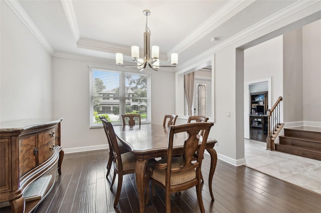 11624 Calf Path Dr, Tampa, FL 33626 - dining space featuring a chandelier, dark wood-type flooring, a raised ceiling, crown molding, and stairs