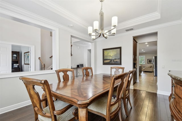 11624 Calf Path Dr, Tampa, FL 33626 - dining area featuring a chandelier, dark wood-style floors, ornamental molding, stairs, and baseboards