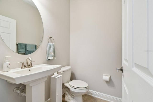 11624 Calf Path Dr, Tampa, FL 33626 - bathroom featuring toilet, baseboards, a sink, and tile patterned floors