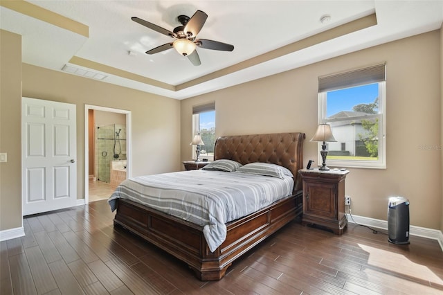 11624 Calf Path Dr, Tampa, FL 33626 - bedroom with a raised ceiling, baseboards, and dark wood-type flooring