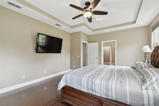 11624 Calf Path Dr, Tampa, FL 33626 - bedroom with a tray ceiling, baseboards, dark wood-type flooring, and ceiling fan