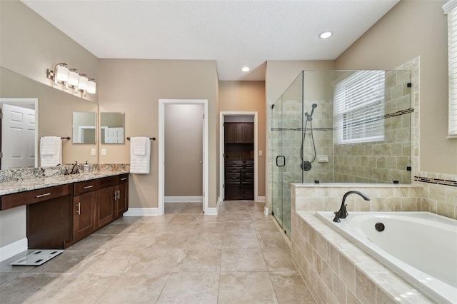 11624 Calf Path Dr, Tampa, FL 33626 - full bathroom featuring a shower stall, a garden tub, vanity, and baseboards