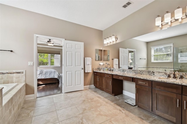 11624 Calf Path Dr, Tampa, FL 33626 - ensuite bathroom featuring a stall shower, double vanity, a bath, ceiling fan, and baseboards