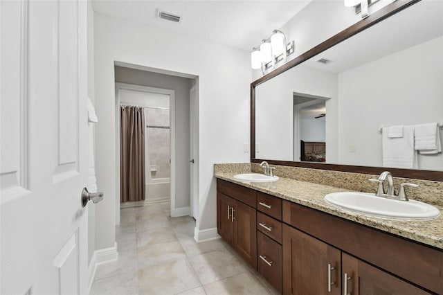 11624 Calf Path Dr, Tampa, FL 33626 - bathroom with double vanity, tile patterned floors, shower / bathtub combination with curtain, and baseboards