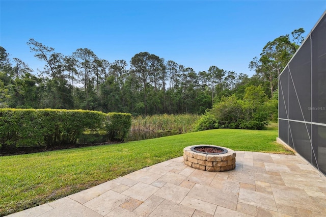 11624 Calf Path Dr, Tampa, FL 33626 - view of patio with an outdoor fire pit and a lanai