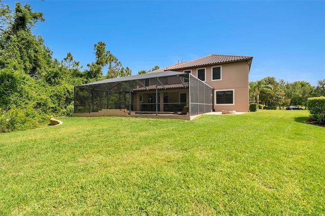 11624 Calf Path Dr, Tampa, FL 33626 - back of property featuring stucco siding, a lawn, and glass enclosure