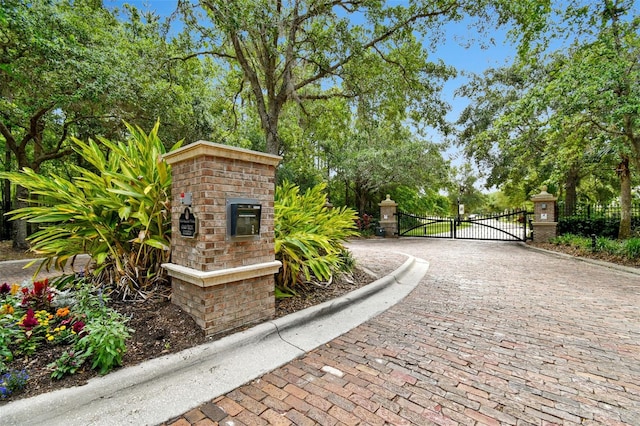 11624 Calf Path Dr, Tampa, FL 33626 - gate featuring fence and view of wooded area