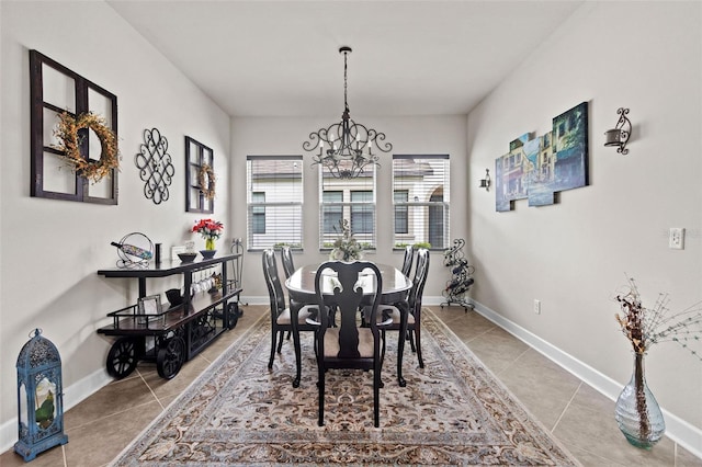 4195 Barletta Ct, Wesley Chapel, FL 33543 - tiled dining space featuring a chandelier and baseboards