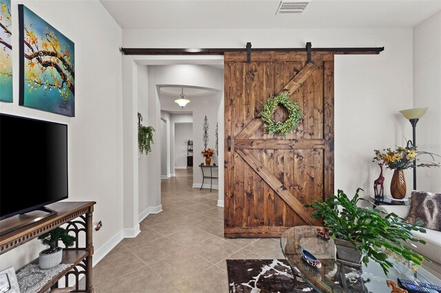 4195 Barletta Ct, Wesley Chapel, FL 33543 - foyer entrance featuring light tile patterned flooring and a barn door