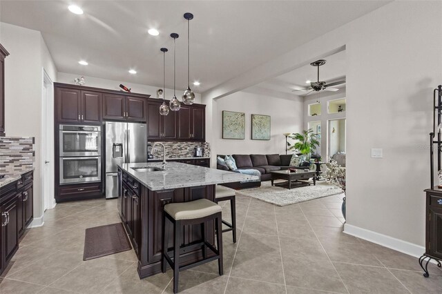 4195 Barletta Ct, Wesley Chapel, FL 33543 - kitchen with appliances with stainless steel finishes, ceiling fan, tasteful backsplash, recessed lighting, and light tile patterned flooring