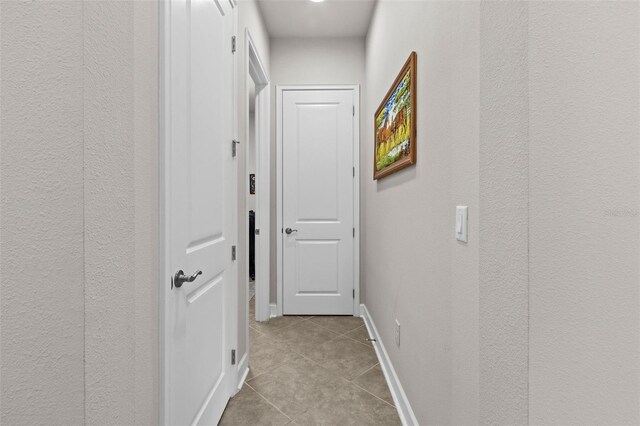 4195 Barletta Ct, Wesley Chapel, FL 33543 - corridor featuring light tile patterned flooring and a textured wall