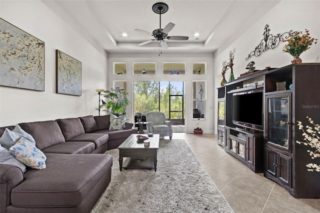 4195 Barletta Ct, Wesley Chapel, FL 33543 - living room featuring light tile patterned floors, a tray ceiling, a ceiling fan, recessed lighting, and a high ceiling
