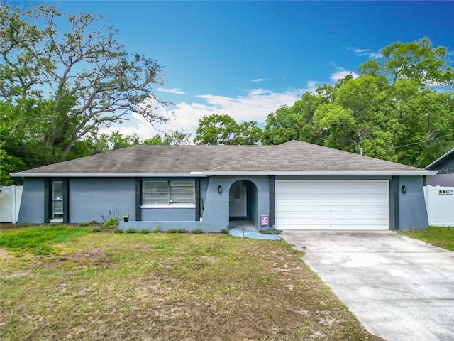 ranch-style house with a garage, stucco siding, concrete driveway, and roof with shingles