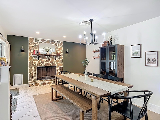 dining room with a chandelier, a fireplace, and recessed lighting