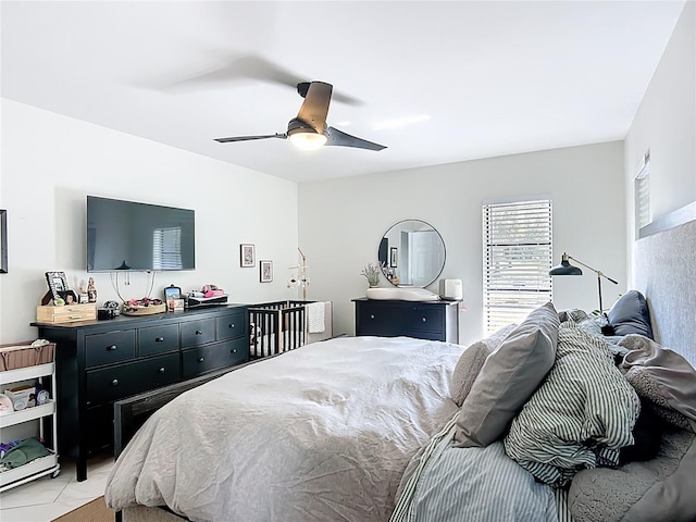 bedroom featuring a ceiling fan and light tile patterned floors