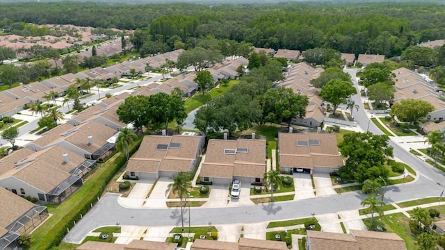 aerial view of property and surrounding area with nearby suburban area and a forest
