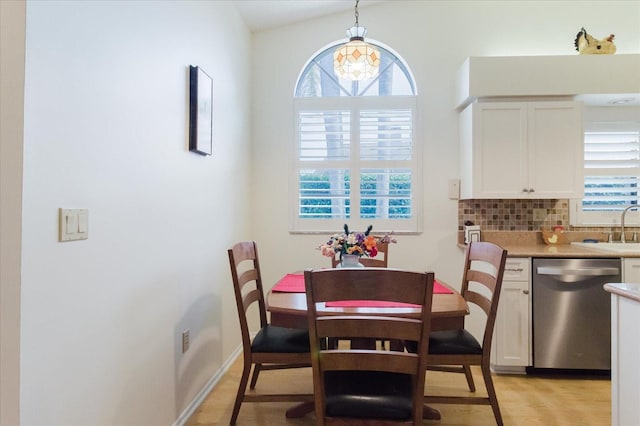 dining room featuring light wood-style floors and baseboards