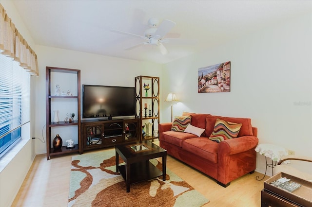 living room featuring wood finished floors and a ceiling fan