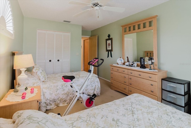 carpeted bedroom with a closet, a ceiling fan, and baseboards