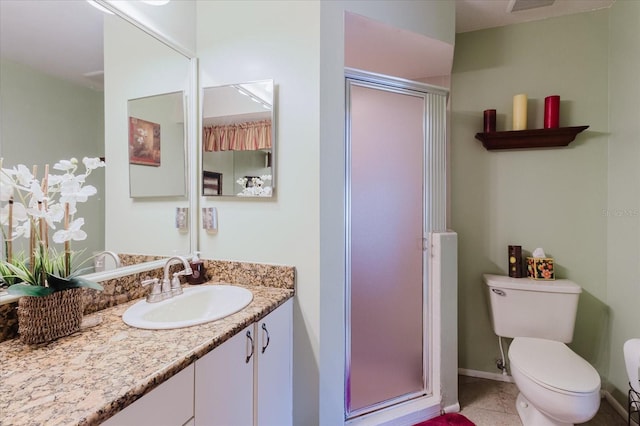 full bath with a shower stall, toilet, vanity, tile patterned flooring, and baseboards