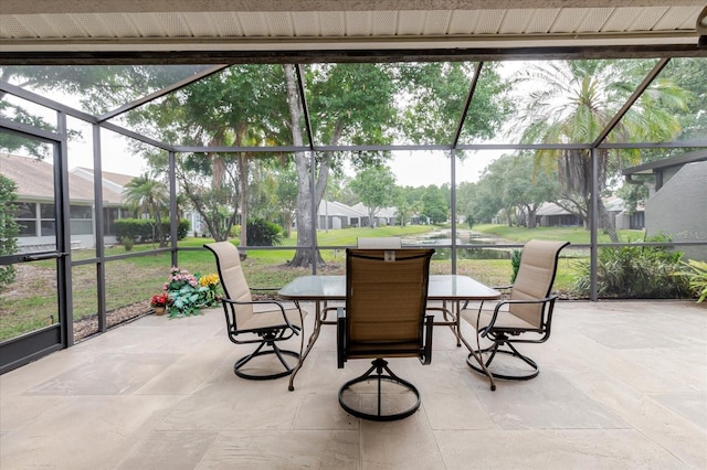 sunroom / solarium featuring outdoor dining space