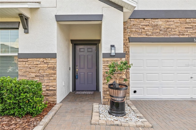 3212 Calvano Dr, Land O Lakes, FL 34639 - view of exterior entry featuring stucco siding, stone siding, and an attached garage
