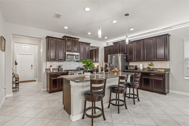 3212 Calvano Dr, Land O Lakes, FL 34639 - kitchen with stainless steel appliances, decorative backsplash, light tile patterned floors, and recessed lighting