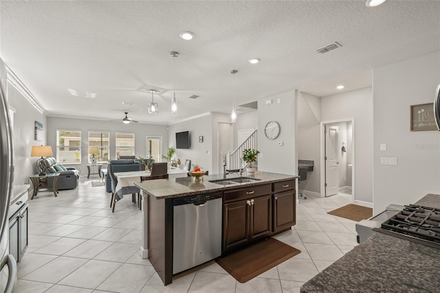 3212 Calvano Dr, Land O Lakes, FL 34639 - kitchen with dishwasher, dark stone counters, a sink, light tile patterned flooring, and open floor plan