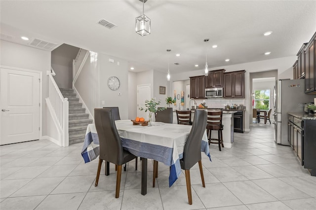 3212 Calvano Dr, Land O Lakes, FL 34639 - dining room with stairs, light tile patterned floors, and recessed lighting