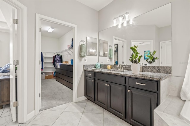 3212 Calvano Dr, Land O Lakes, FL 34639 - bathroom with vanity, a spacious closet, and baseboards