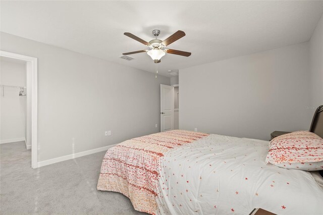 3212 Calvano Dr, Land O Lakes, FL 34639 - bedroom featuring a spacious closet, carpet floors, baseboards, ceiling fan, and a closet