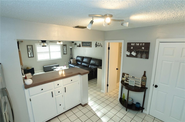 300 6th St N Unit E3, Safety Harbor, FL 34695 - kitchen with white cabinetry, light tile patterned floors, a textured ceiling, and open floor plan