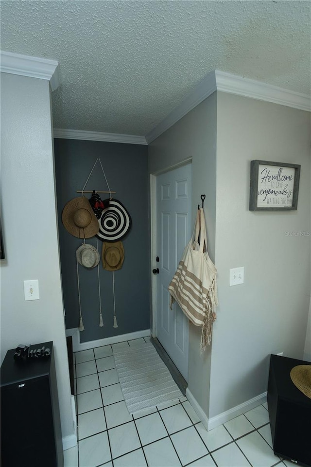 300 6th St N Unit E3, Safety Harbor, FL 34695 - entrance foyer with light tile patterned floors, a textured ceiling, crown molding, and baseboards