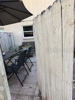 300 6th St N Unit E3, Safety Harbor, FL 34695 - view of patio featuring fence and outdoor dining space