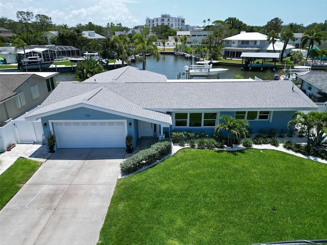 1769 Brookside Blvd, Largo, FL 33770 - view of front of home with an attached garage, concrete driveway, stucco siding, a water view, and a shingled roof