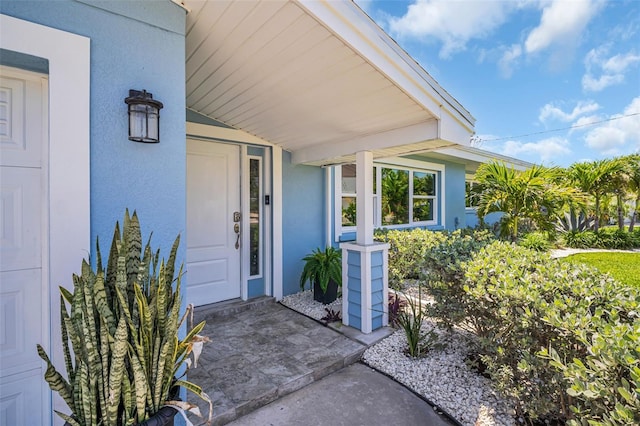 1769 Brookside Blvd, Largo, FL 33770 - view of exterior entry with stucco siding and covered porch